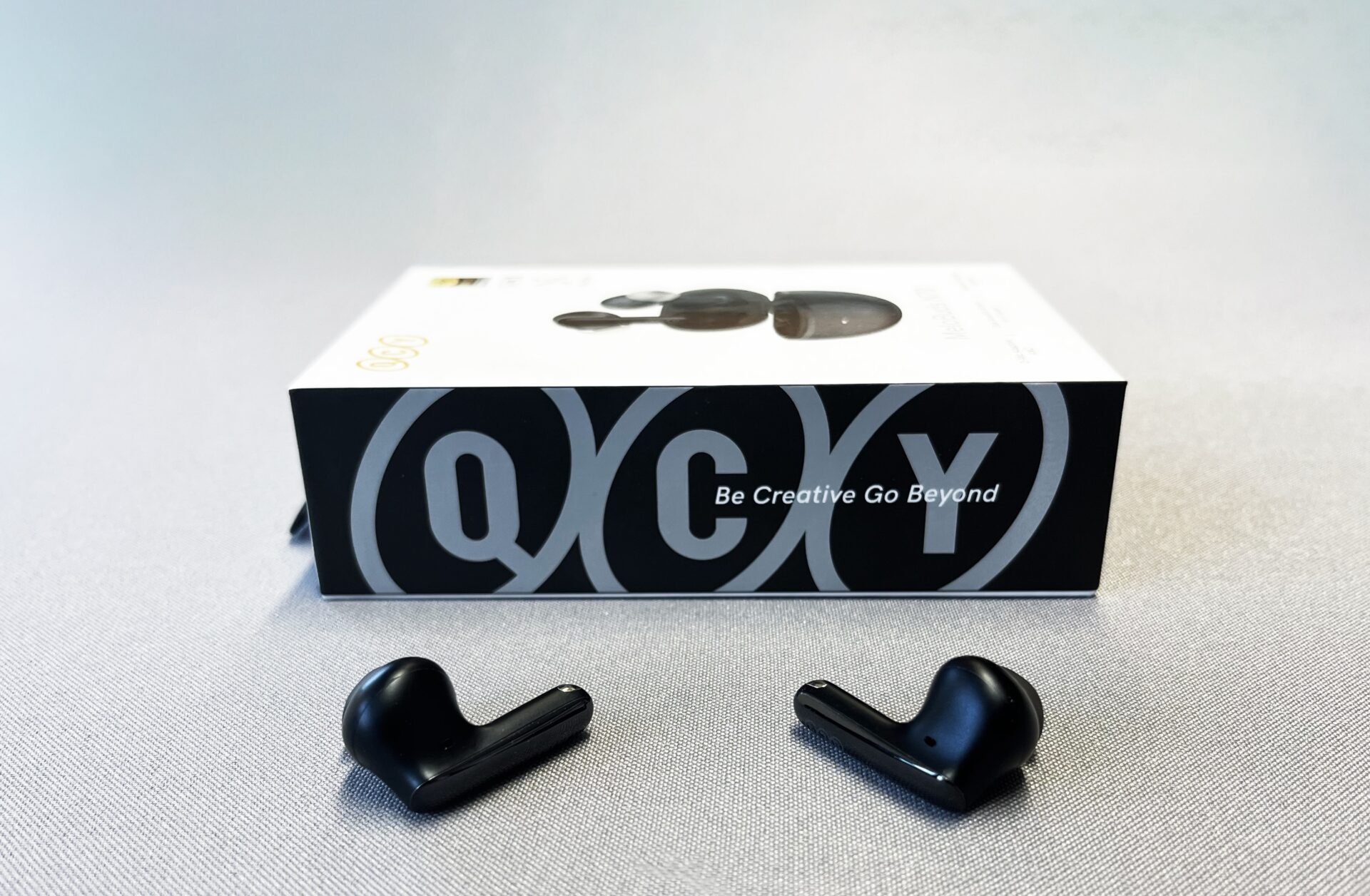 QCY Melobuds N70 featuring USound MEMS speakers on a table